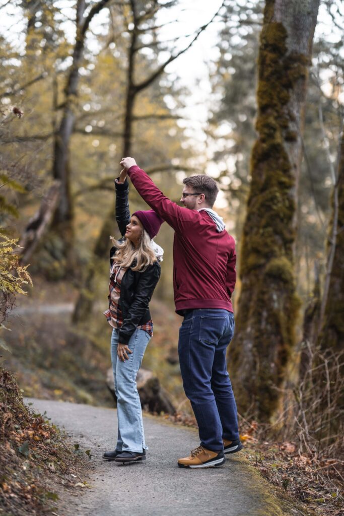 couple dancing on trail for engagement session in Oregon