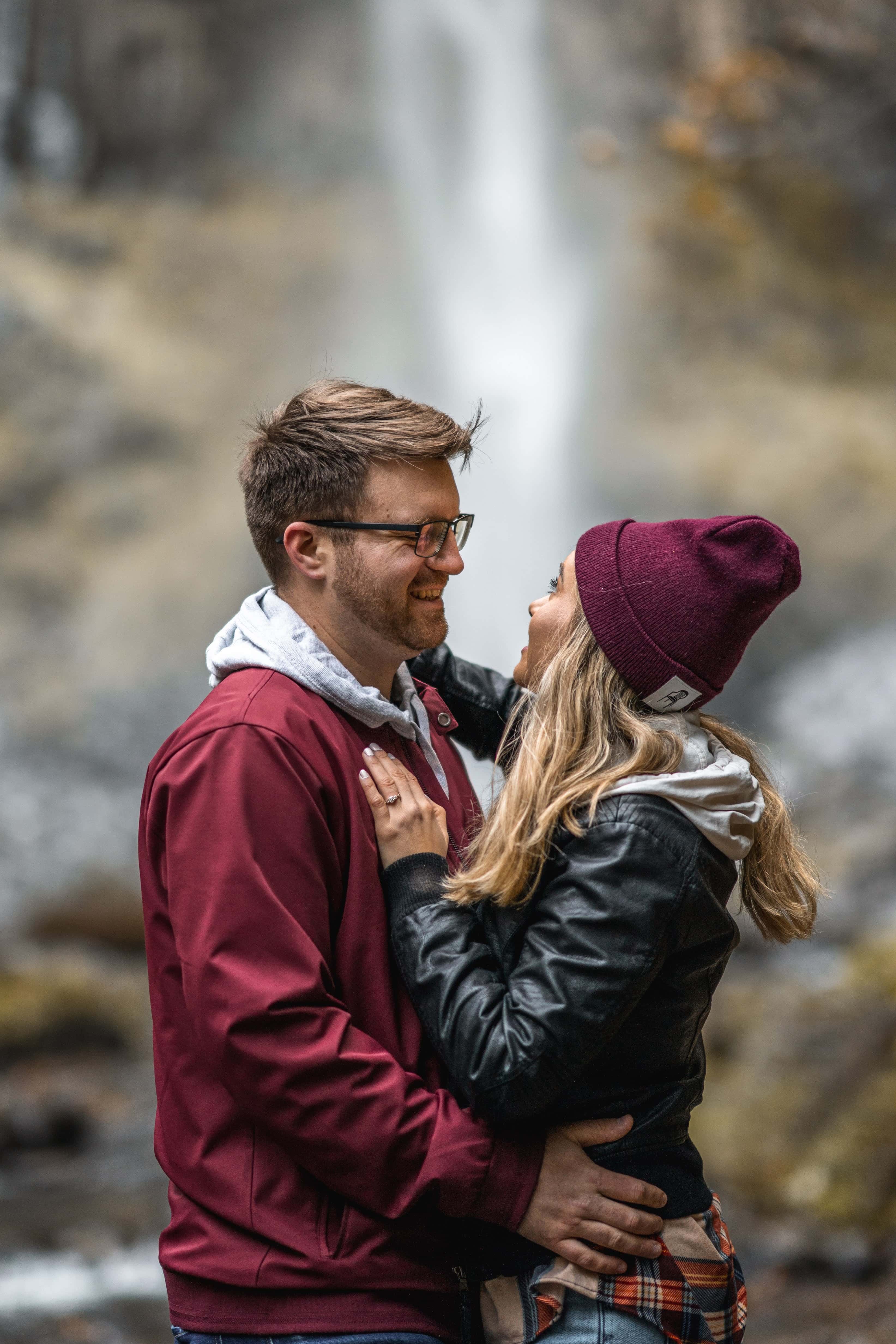 Couple looking up at waterfall