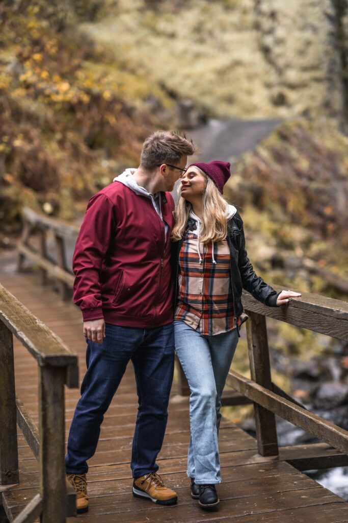 Couple hiking on bridge over latourell Falls