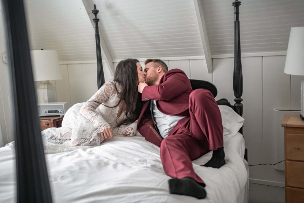 couple kiss in wedding apparel in small cabin