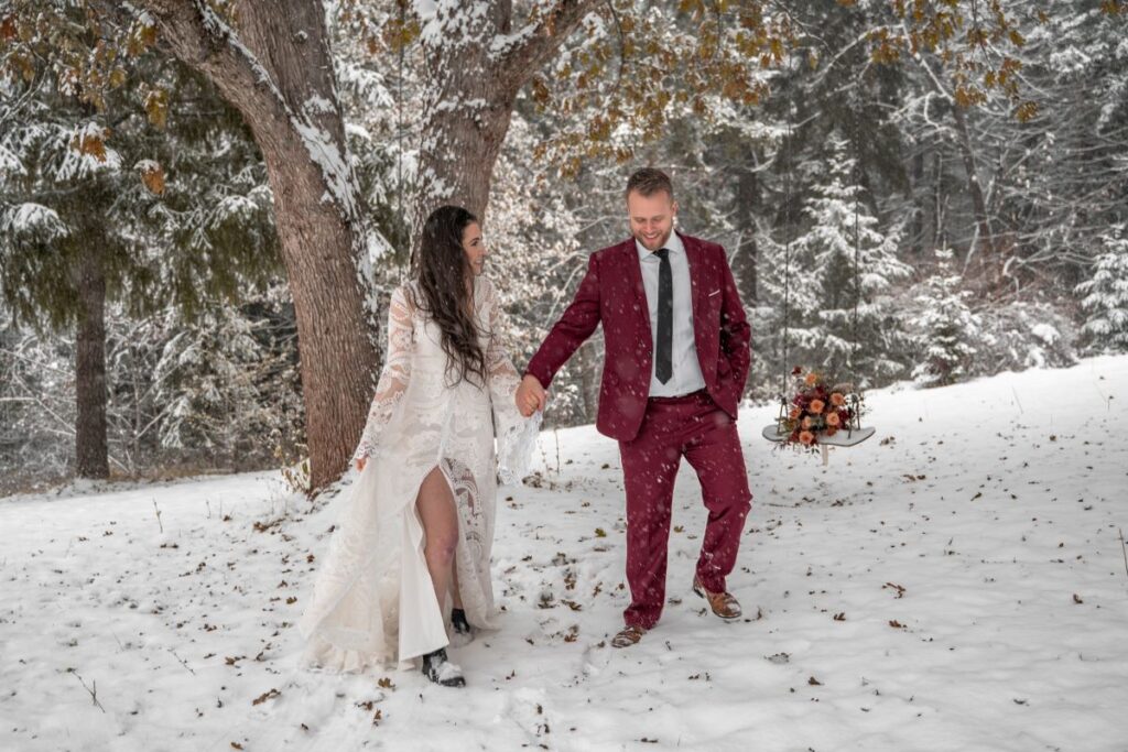 wedding couple adventures in snow in winter snowy forest