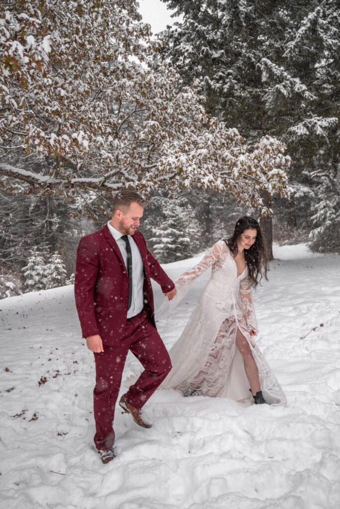 bride and groom hike through snow in winter adventure elopement in Oregon